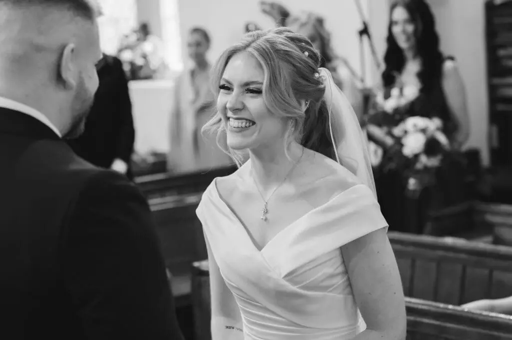 Hiring a professional wedding photographer - close up of a pretty bride smiling brightly
