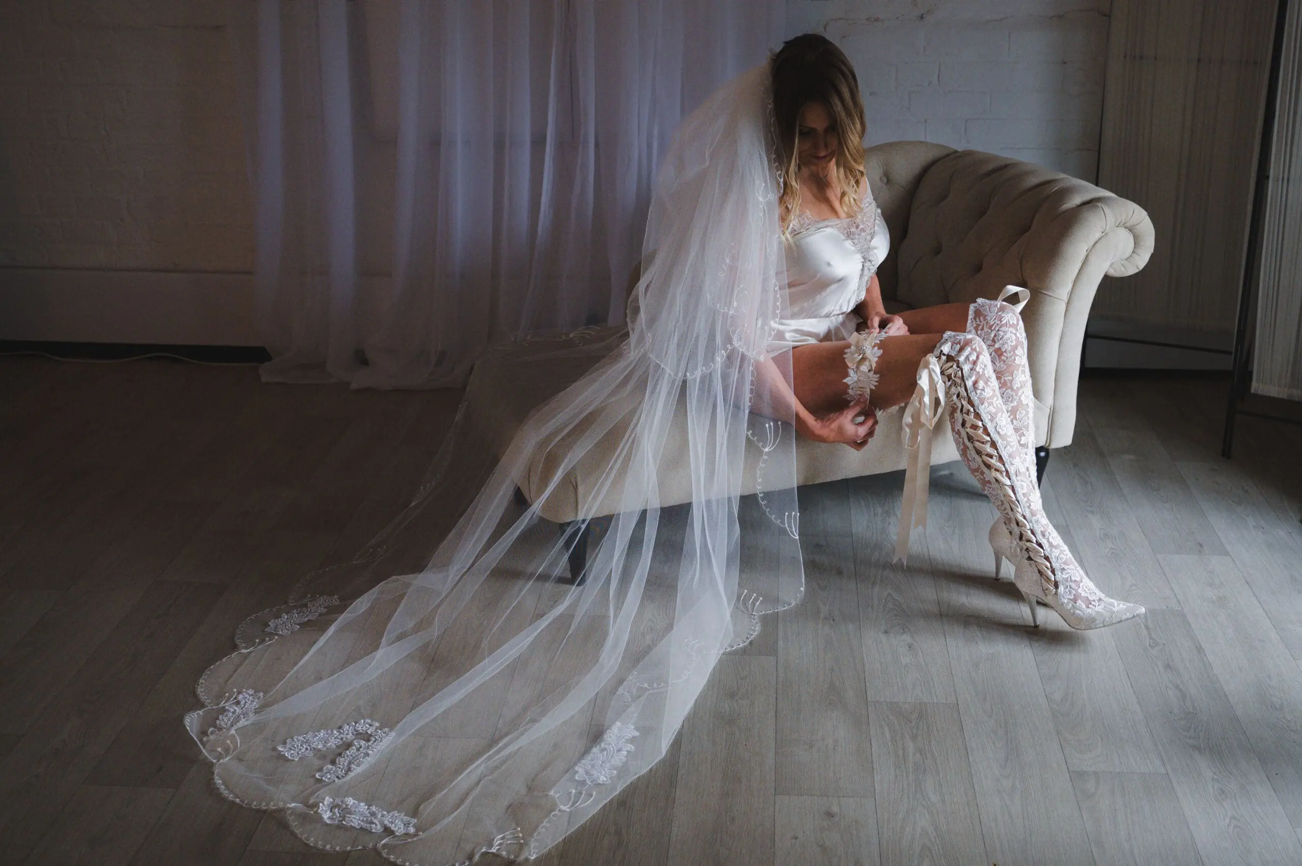 Zoe_-53 Boudoir Photography Prices - A bride in her veil and just her sexy white underwear sitting on a chaise