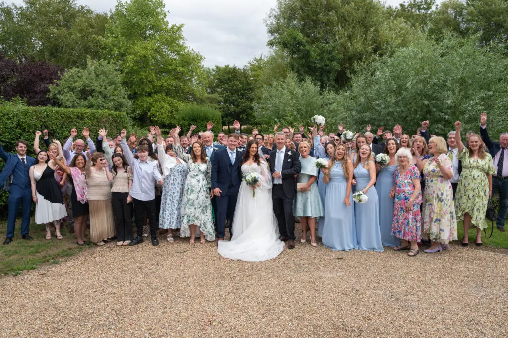 Bride and Groom with all their guests outside in the grounds of their perfect wedding venue, Granary Estates