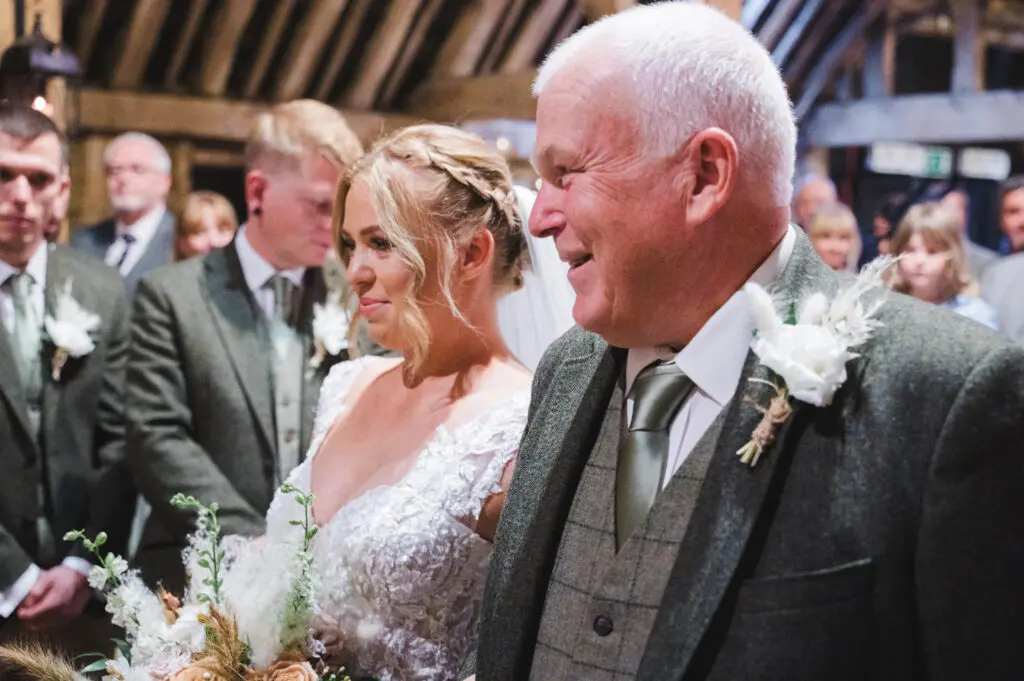 Bride with her dad as they get to the end of the aisle - not on the Wedding Photo List