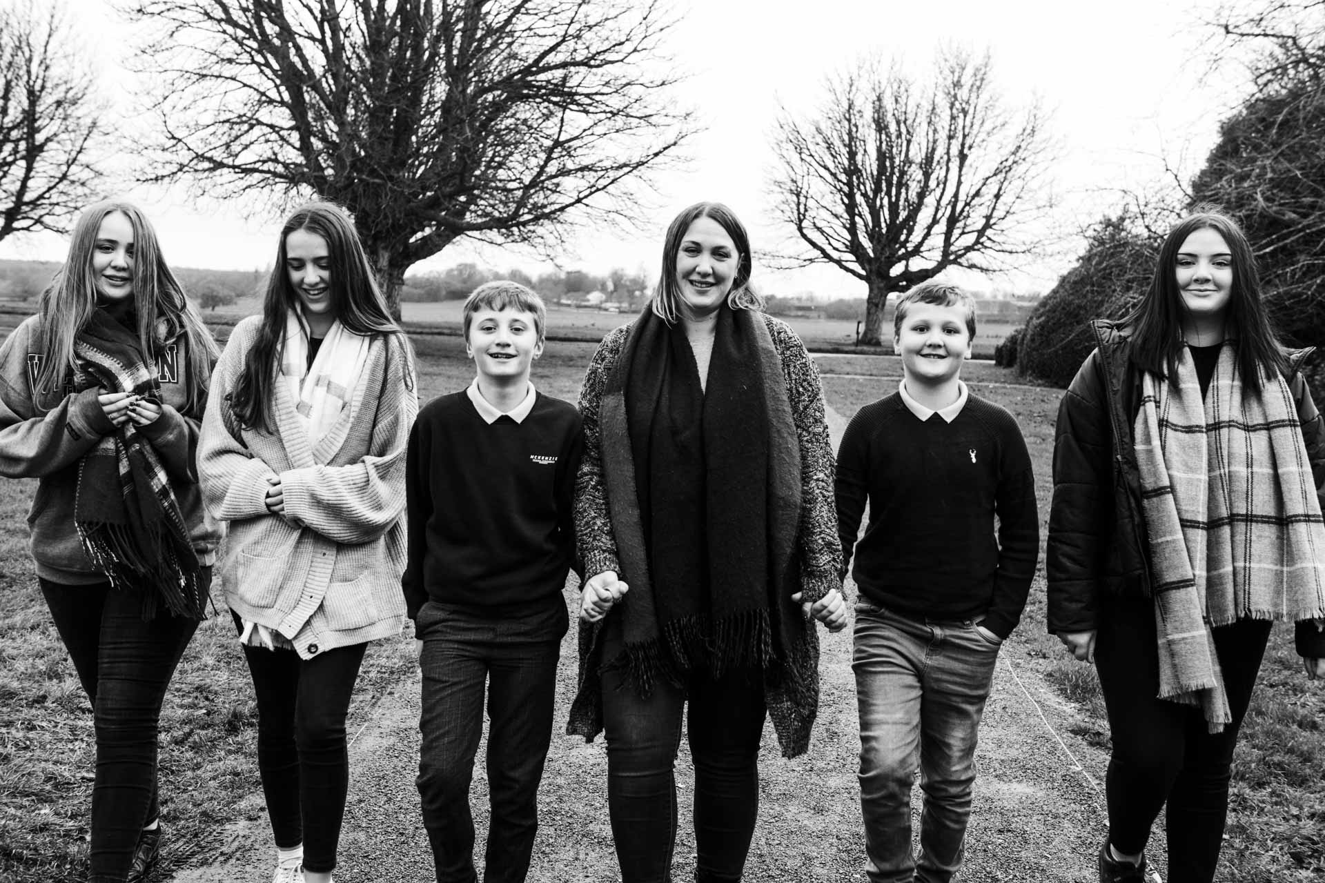 Family Photography Prices - a group of children walking towards the camera, image in black and white - Wrest Park