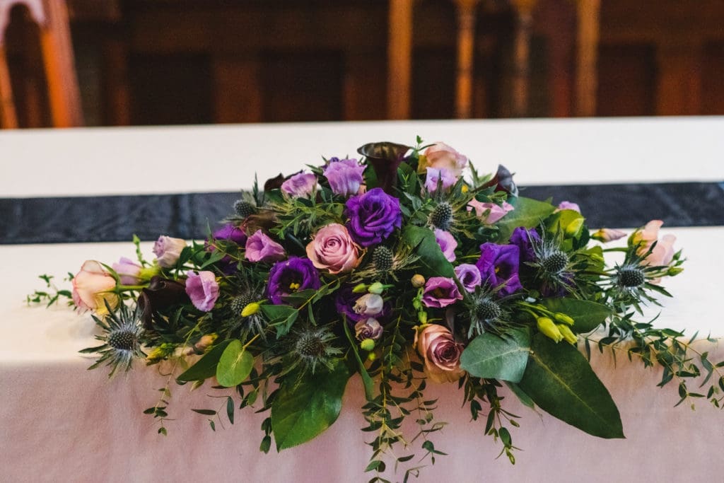 Winter Wedding Floral Trends a deep purple table arrangement