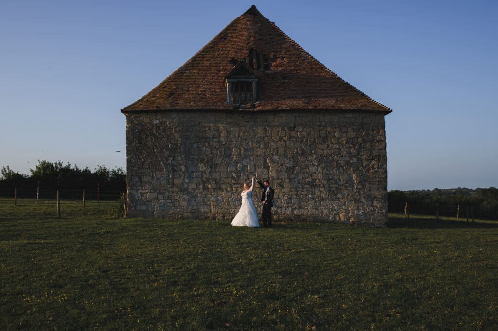 Buckinghamshire's Notely Tythe Barn - a bridal Couple dance in front of the barn wall.